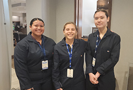  three girls in crime scene investigation uniforms stand together